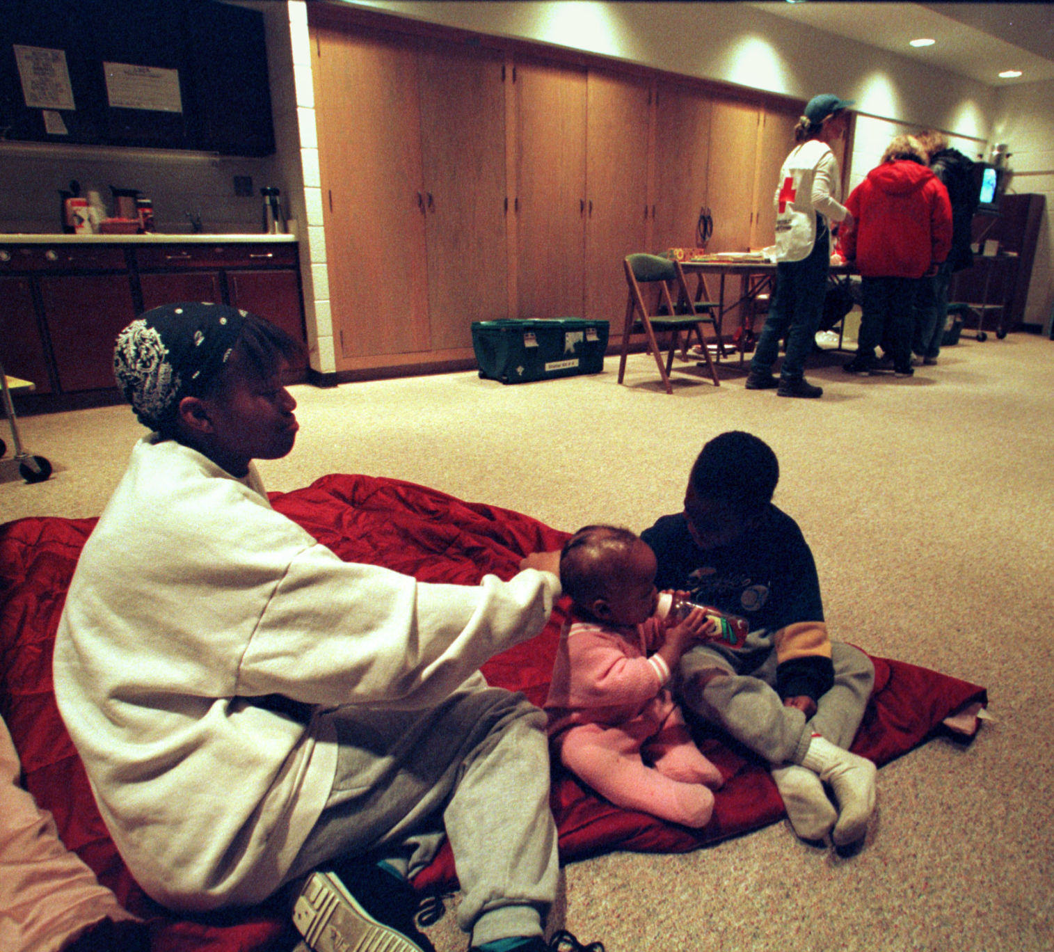 Wakonda Hazel and her children, LaChelle, 9 mos., and Davonte, 4, prepare for the night at St. Paul United Methodist Chruch near 54th and NW Radial Sts., in Omaha on Oct. 26, 1997. Their apartment, near 48th and Sahler, is without power or heat.